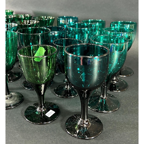 1121 - Fifteen trumpet 19th century wine glasses in various shades of green and thirteen similar wine glass... 