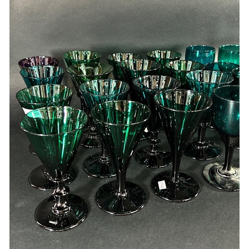 1121 - Fifteen trumpet 19th century wine glasses in various shades of green and thirteen similar wine glass... 