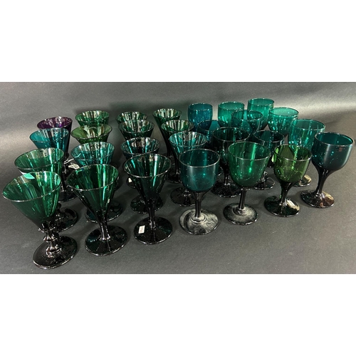 1121 - Fifteen trumpet 19th century wine glasses in various shades of green and thirteen similar wine glass... 