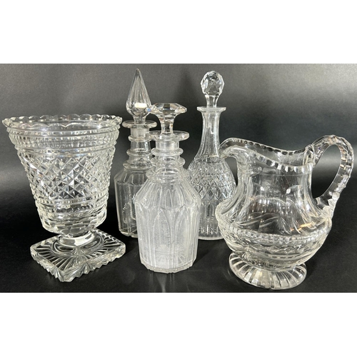 1132 - Three late 19th and early 20th century cut glass decanters, a vase and a glass water jug.