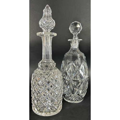 1144 - A pair of slender waisted cut glass vases, 29cm high, and two cut glass decanters.