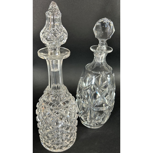 1144 - A pair of slender waisted cut glass vases, 29cm high, and two cut glass decanters.