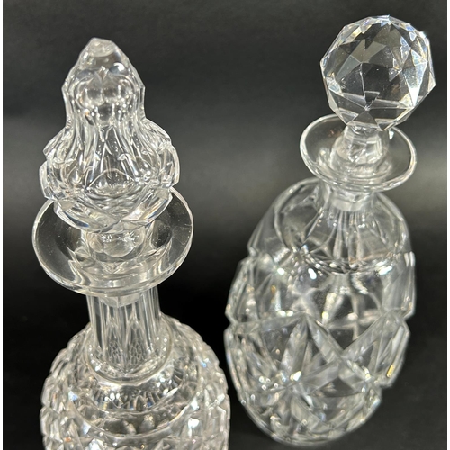 1144 - A pair of slender waisted cut glass vases, 29cm high, and two cut glass decanters.