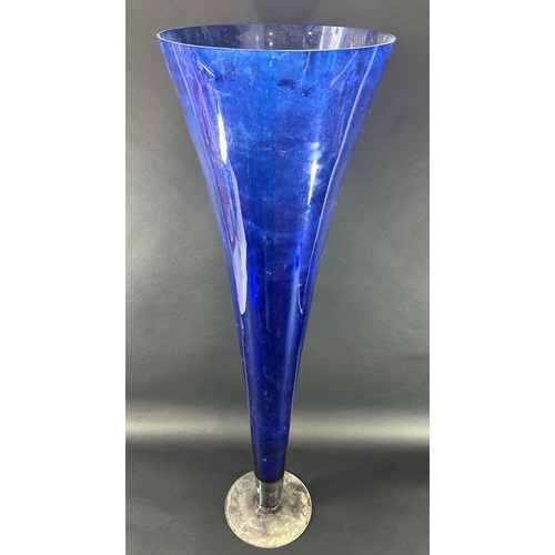 1124 - A pair of large blue flared trumpet vases with a clear circular foot, both standing one metre tall