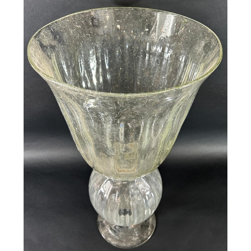 1125 - A large clear bubble glass vase with a campana shaped bowl raised on spherical section set on a spre... 