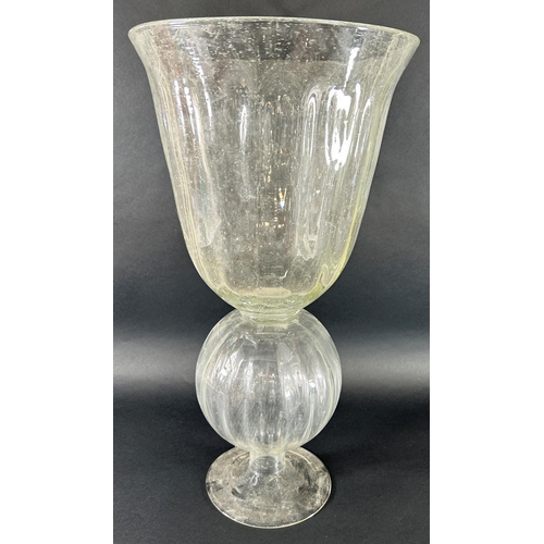 1125 - A large clear bubble glass vase with a campana shaped bowl raised on spherical section set on a spre... 