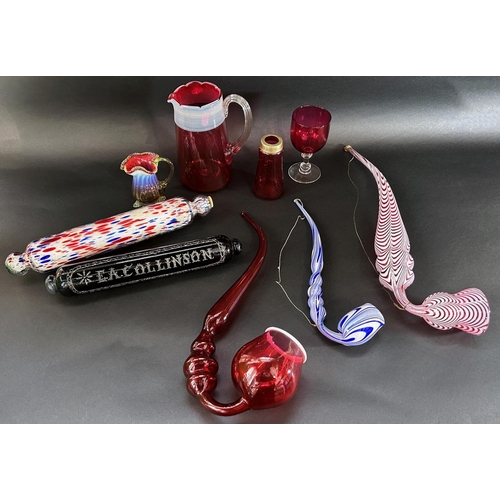 1126 - Victorian novelty glassware including a cranberry glass pipe, a Nailsea red glass pipe, Stourbridge ... 