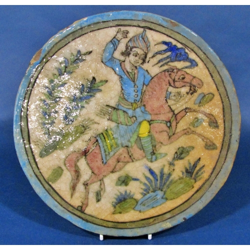 1036 - A large circular Iznik type earthenware tile, decorated with horse and rider, impressed decoration o... 
