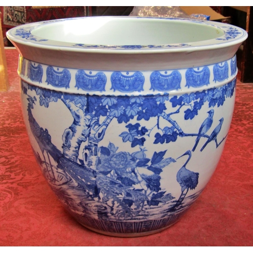 1055 - A large Chinese blue and white porcelain jardiniere / fish bowl decorated with birds amongst foliage... 