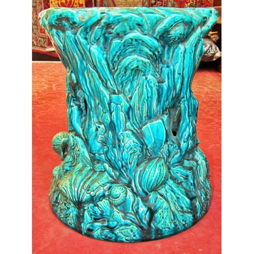 1056 - A 19th century majolica type jardiniere stand of tree stump form, decorated with applied shells, tur... 