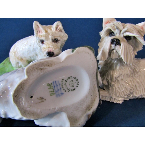 1061 - A group of models of West Highland terriers to include a small Royal Worcester example of a seated W... 