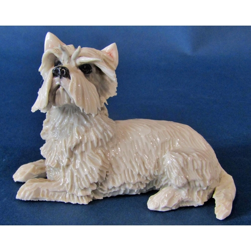 1061 - A group of models of West Highland terriers to include a small Royal Worcester example of a seated W... 