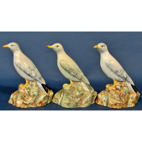 1085 - Three Radford pottery models of standing seagulls, each 22 cm high, together with a novelty three pi... 