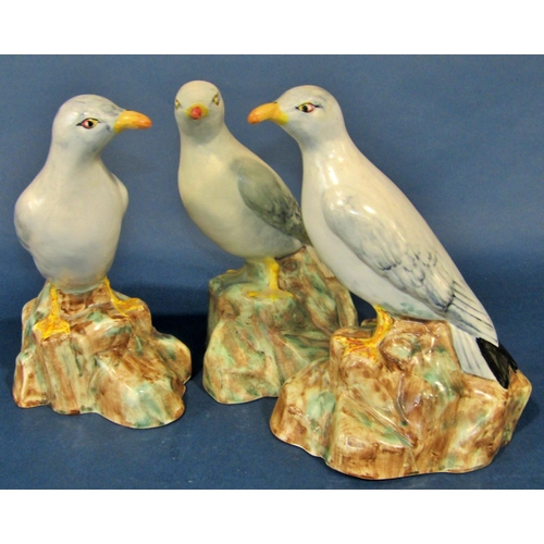 1085 - Three Radford pottery models of standing seagulls, each 22 cm high, together with a novelty three pi... 