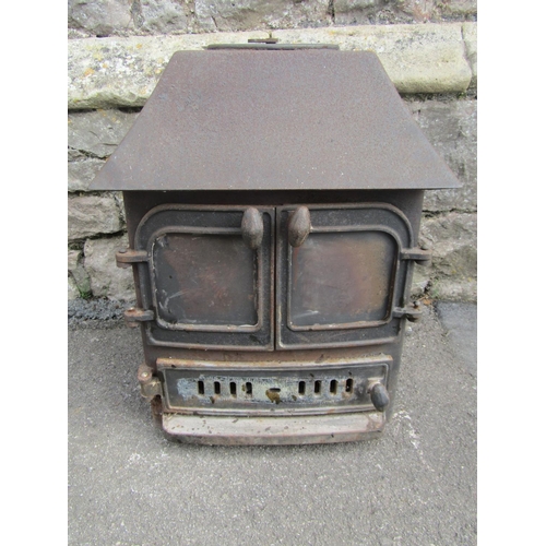 2138 - A cast iron wood/log burning stove, 62cm high x 60cm wide x 50cm deep