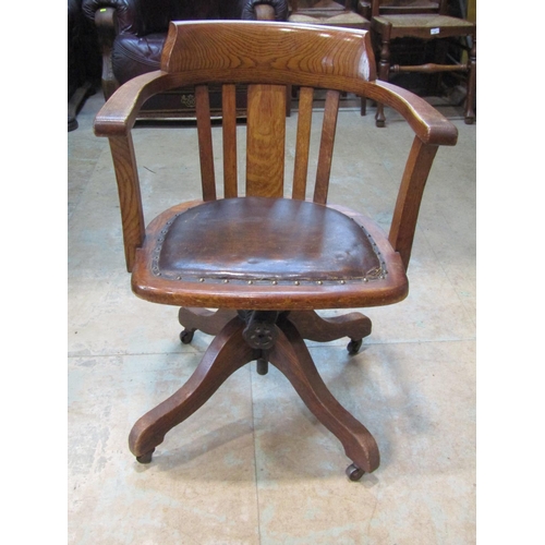 2210 - An early 20th century oak swivel office chair