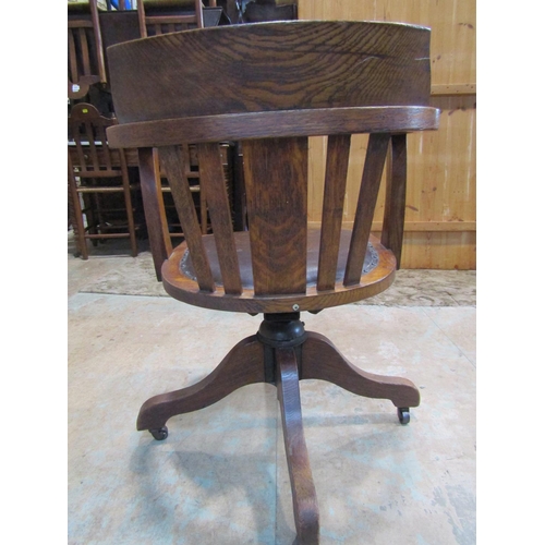 2210 - An early 20th century oak swivel office chair