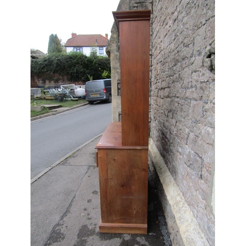 2211 - A small pine kitchen dresser, fitted with two drawers and a pair of panelled doors, below delft rack... 