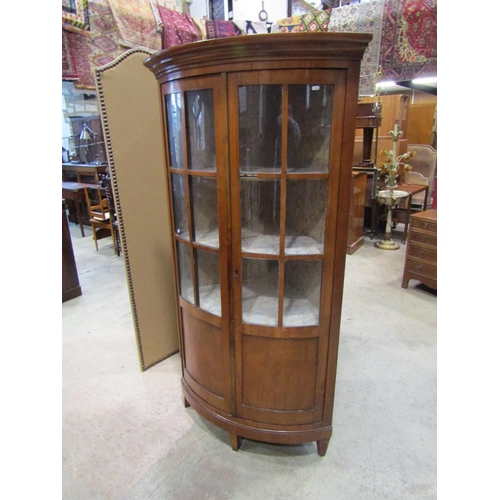 2215 - A late 19th century continental cherry wood bow fronted corner cupboard, 80cm high.