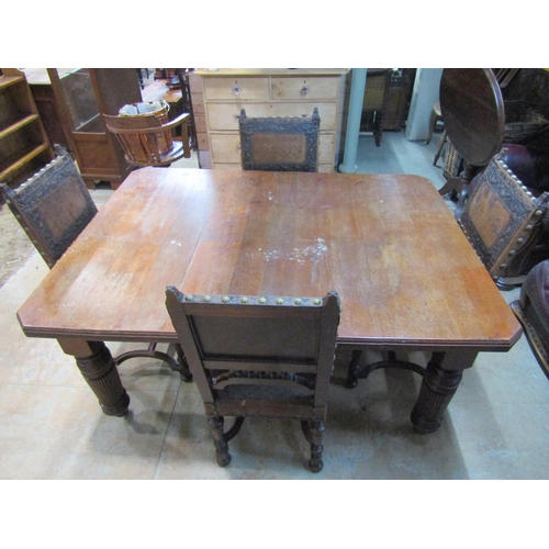 2221 - An Edwardian oak dining table, with canted corners raised on broad fluted supports and casters, 73 c... 