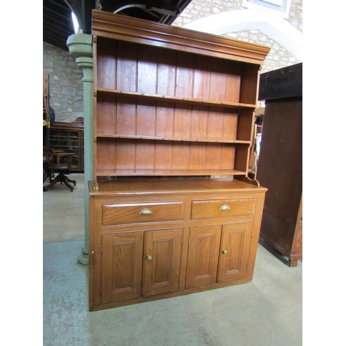 2226 - A grained pine dresser, fitted with two drawers and two pairs of panelled cupboard doors enclosing a... 