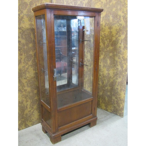 2227 - An early 20th century freestanding display cabinet with mirror panelled back enclosed by a full leng... 