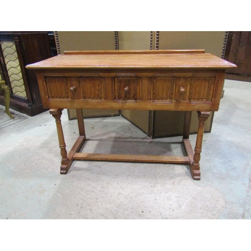 2241 - A small pine side / dressing table, in the Old English / refectory style, fitted with linen fold car... 