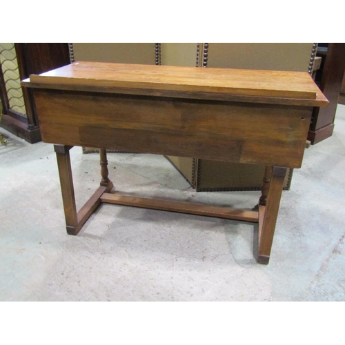 2241 - A small pine side / dressing table, in the Old English / refectory style, fitted with linen fold car... 