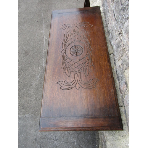 2288 - An Edwardian oak monks bench, with shallow carved detail and arms in the form of lions.