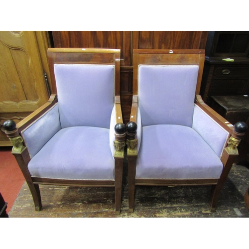 2652 - A pair of Empire style elbow chairs, raised on sabre supports, the show wood frames mounted with ebo... 