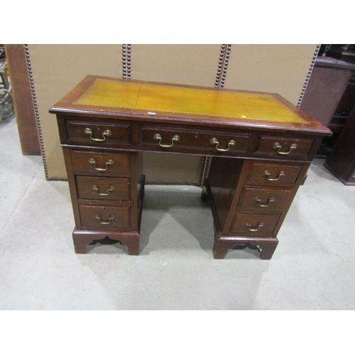 2297 - A small 19th century mahogany pedestal desk, with a tooled leather top over an arrangement of nine d... 