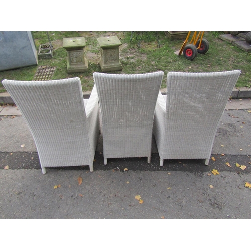 2065 - A pair of good quality rattan garden/conservatory armchairs together with a matching single chair