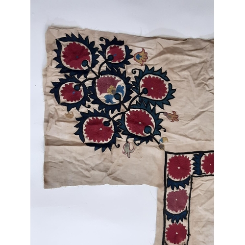 1747 - Suzani panel, possibly 19th century with a central hand embroidered flower motif in crimson surround... 