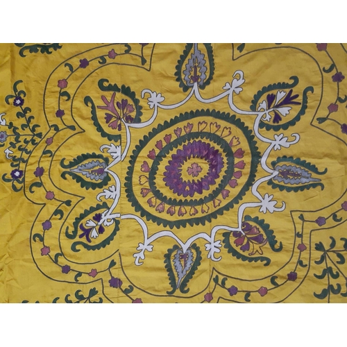 1748 - Large Suzani panel with embroidered floral stems surrounding a central circular motif, on saffron co... 