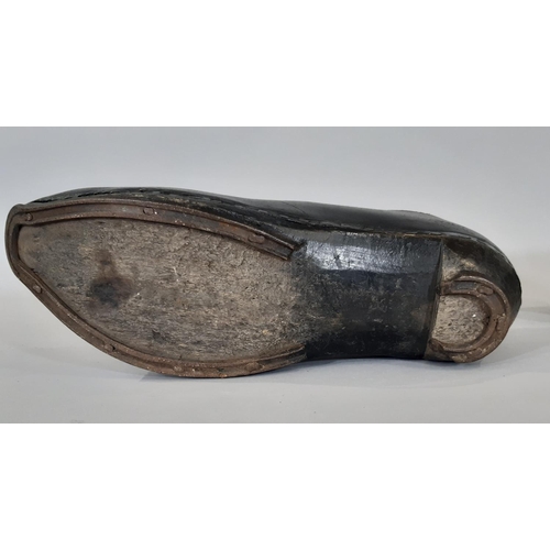 1756 - A pair of late 19th / early 20th century British clogs comprising a black leather upper over a woode... 