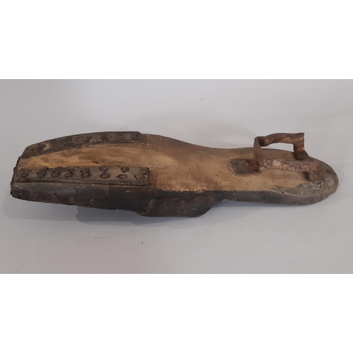 1756 - A pair of late 19th / early 20th century British clogs comprising a black leather upper over a woode... 