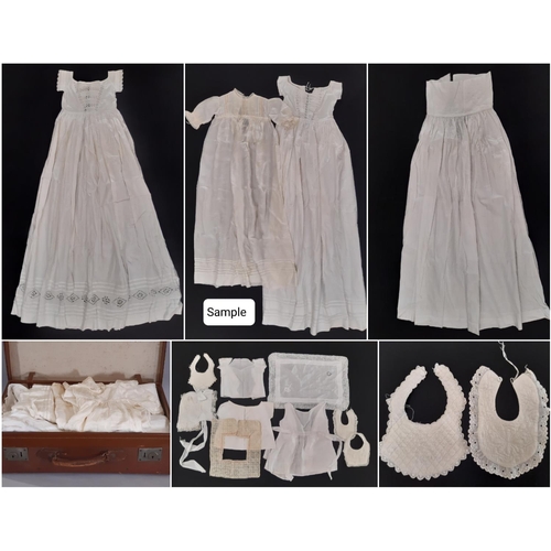 1764 - Suitcase containing a early 20th century baby clothing including full length gowns embellished with ... 