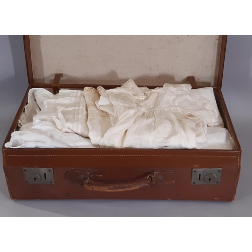 1764 - Suitcase containing a early 20th century baby clothing including full length gowns embellished with ... 