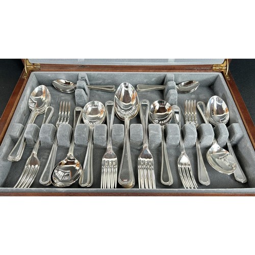 1155 - A Canteen of Sheffield cutlery with beaded handles, complete for eight settings.