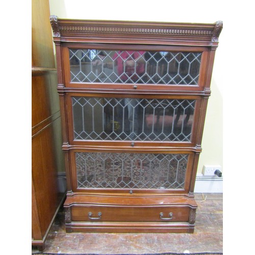 2746 - A four tier globe Wernicke mahogany sectional bookcase. The three leaded light doors over a single d... 