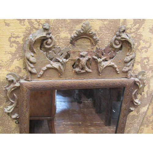 2744 - An antique gilded pier glass, with shaped outline and floral scrolling detail, 110cm high x 55cm wid... 