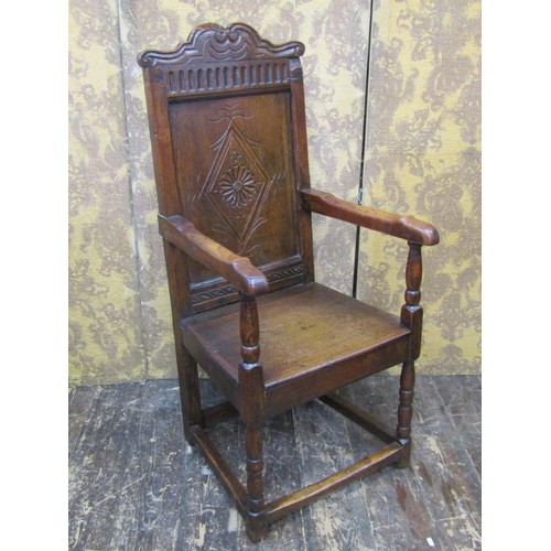 2736 - An old English oak Wainscote chair, the panelled back with lozenge shaped and carved detail, set ben... 