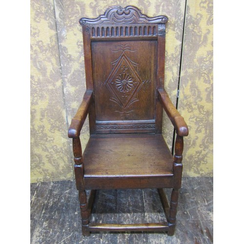 2736 - An old English oak Wainscote chair, the panelled back with lozenge shaped and carved detail, set ben... 