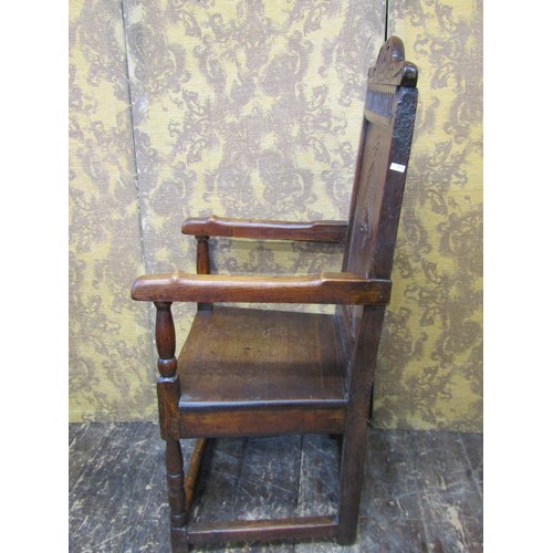 2736 - An old English oak Wainscote chair, the panelled back with lozenge shaped and carved detail, set ben... 