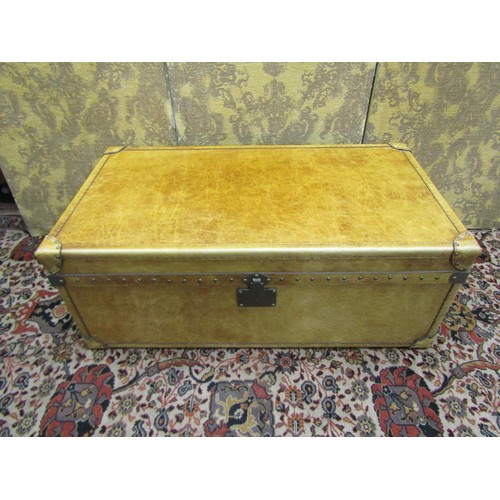 2718 - A good quality travelling trunk ottoman with pale tan coloured leather finish and studwork borders, ... 