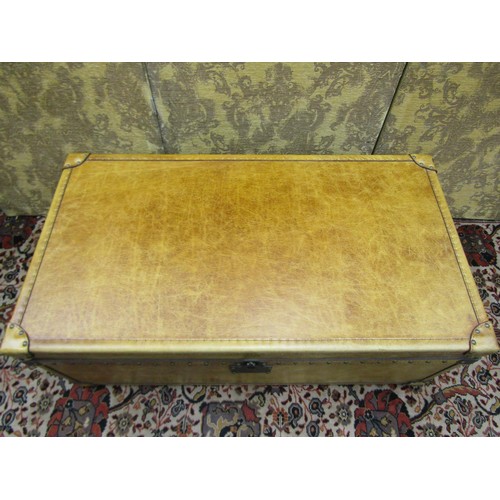 2718 - A good quality travelling trunk ottoman with pale tan coloured leather finish and studwork borders, ... 