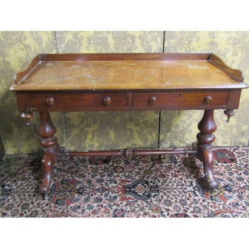 2711 - A mid Victorian period mahogany side table enclosing two frieze drawers with three quarter gallery a... 