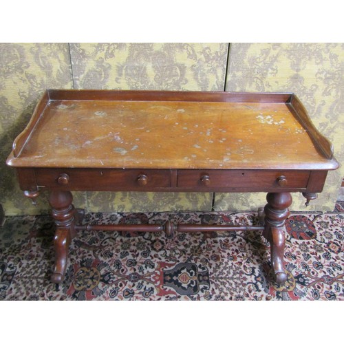 2711 - A mid Victorian period mahogany side table enclosing two frieze drawers with three quarter gallery a... 