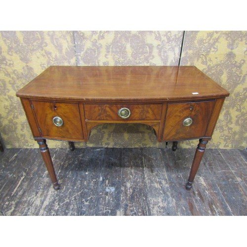 2707 - A Regency mahogany side table, the central drawer flanked by further drawer and cupboard, raised on ... 