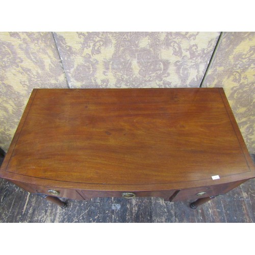 2707 - A Regency mahogany side table, the central drawer flanked by further drawer and cupboard, raised on ... 